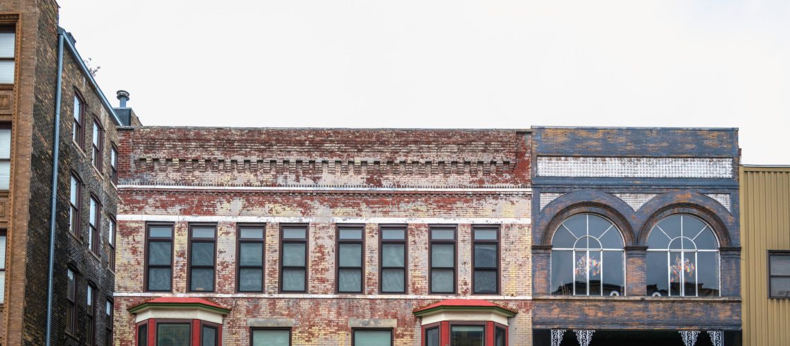 Facade of historic downtown rustic brick buildings in Bloomington City, Illinois